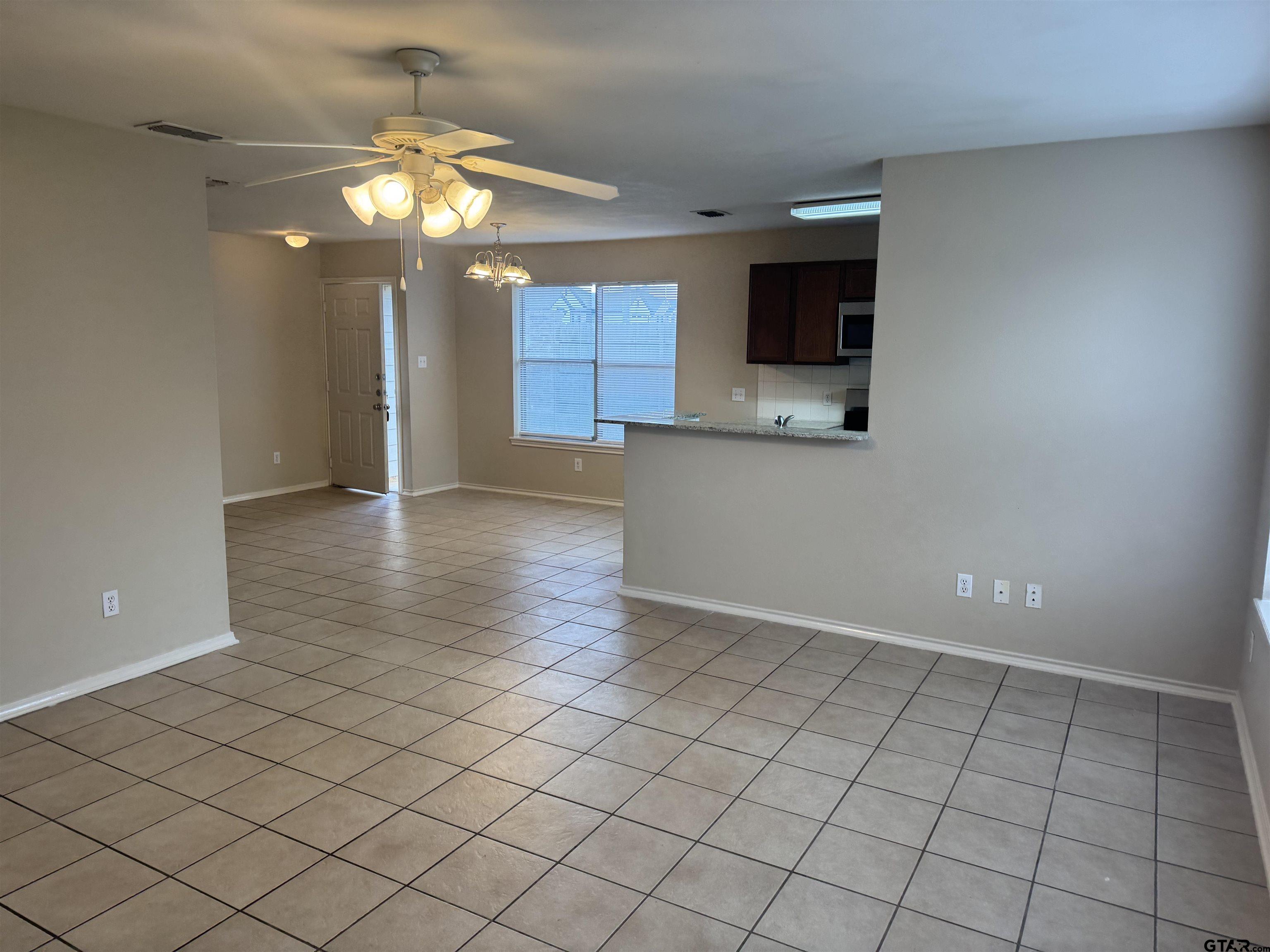 613 Hagan Road Whitehouse, TX 75791 - Photo 6 of 22 an empty room with kitchen view