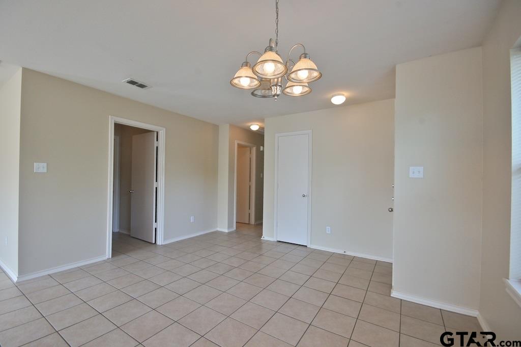 613 Hagan Road Whitehouse, TX 75791 - Photo 7 of 22 a view of an empty room with a chandelier fan