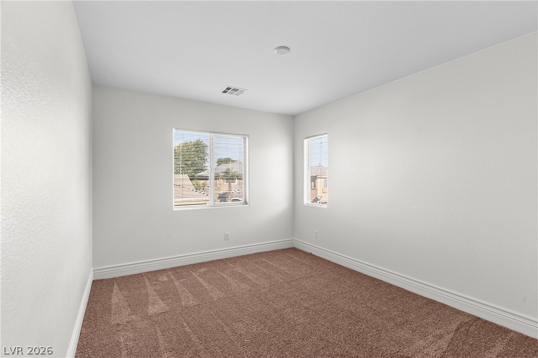 181 Short Ruff Way Las Vegas, NV 89148 - Photo 17 of 43 Spare room featuring dark carpet and baseboards
