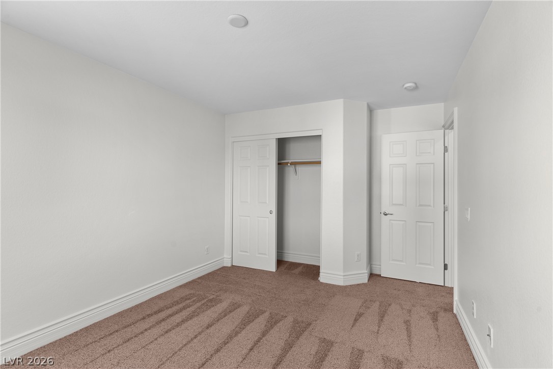 181 Short Ruff Way Las Vegas, NV 89148 - Photo 18 of 43 Unfurnished bedroom featuring carpet and a closet