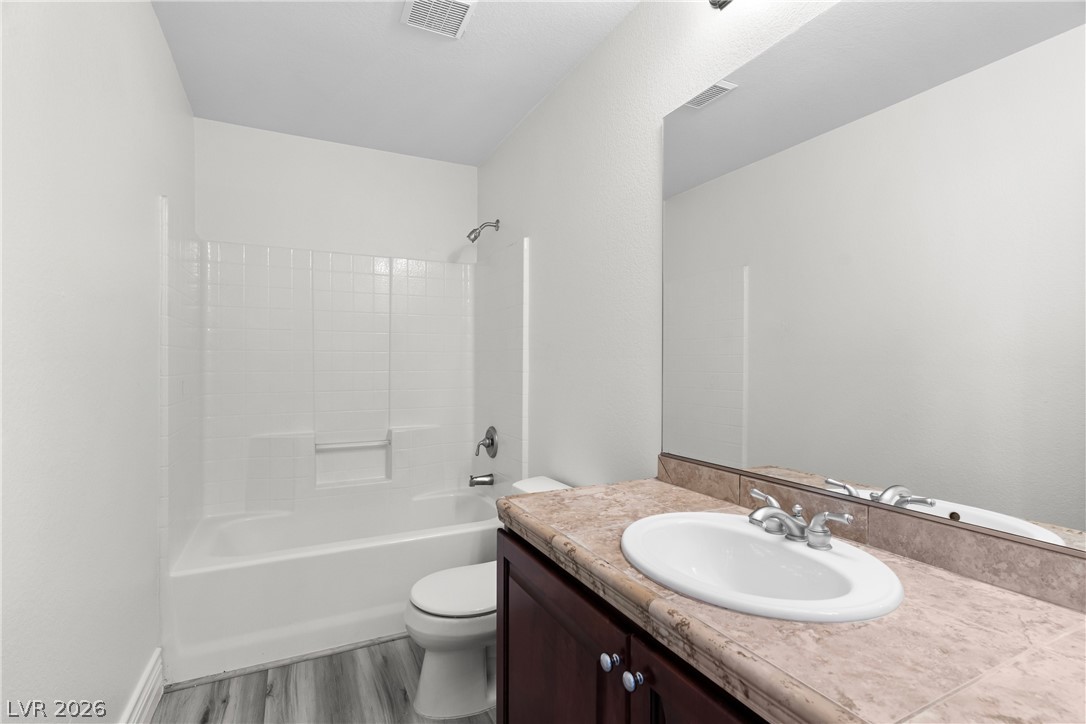 181 Short Ruff Way Las Vegas, NV 89148 - Photo 19 of 43 Full bathroom with vanity, shower / washtub combination, and light wood-type flooring
