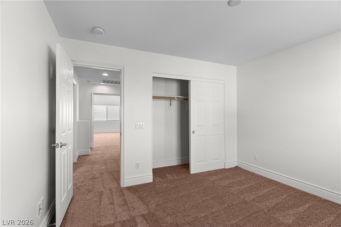 181 Short Ruff Way Las Vegas, NV 89148 - Photo 20 of 43 Unfurnished bedroom featuring dark colored carpet and a closet