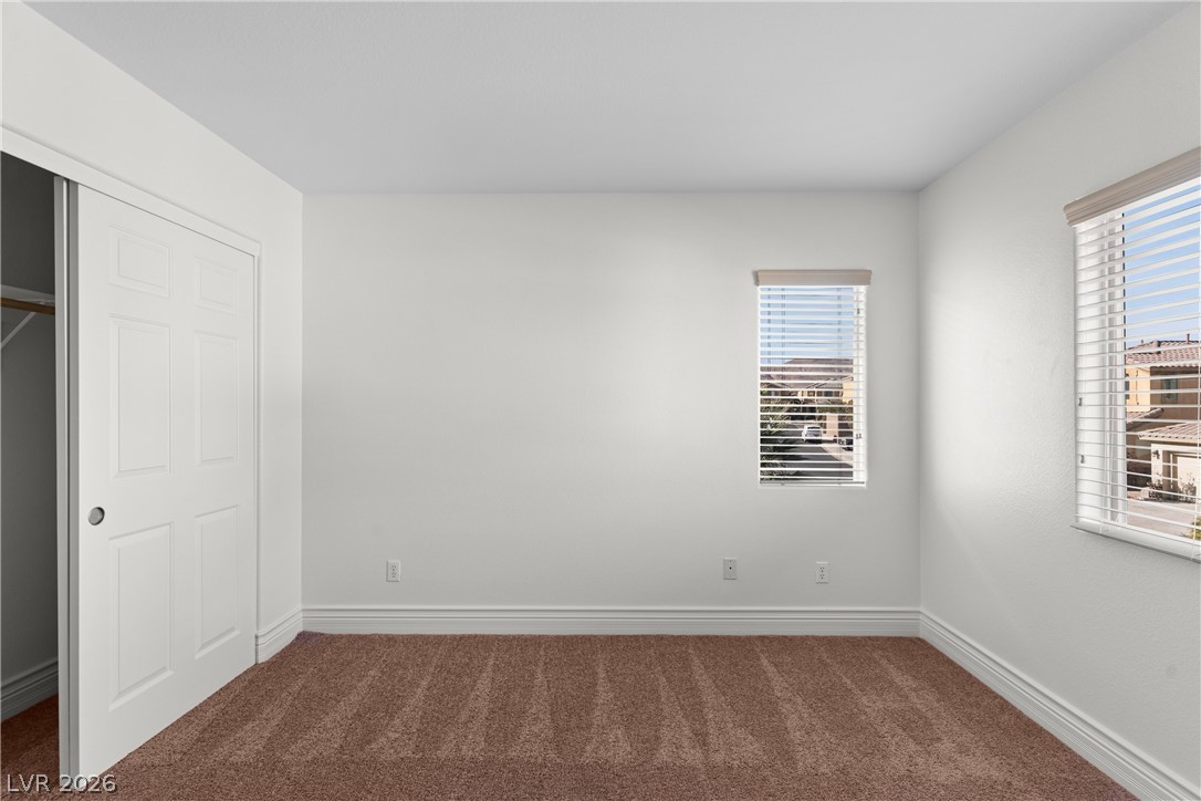 181 Short Ruff Way Las Vegas, NV 89148 - Photo 21 of 43 Unfurnished bedroom with dark carpet and a closet