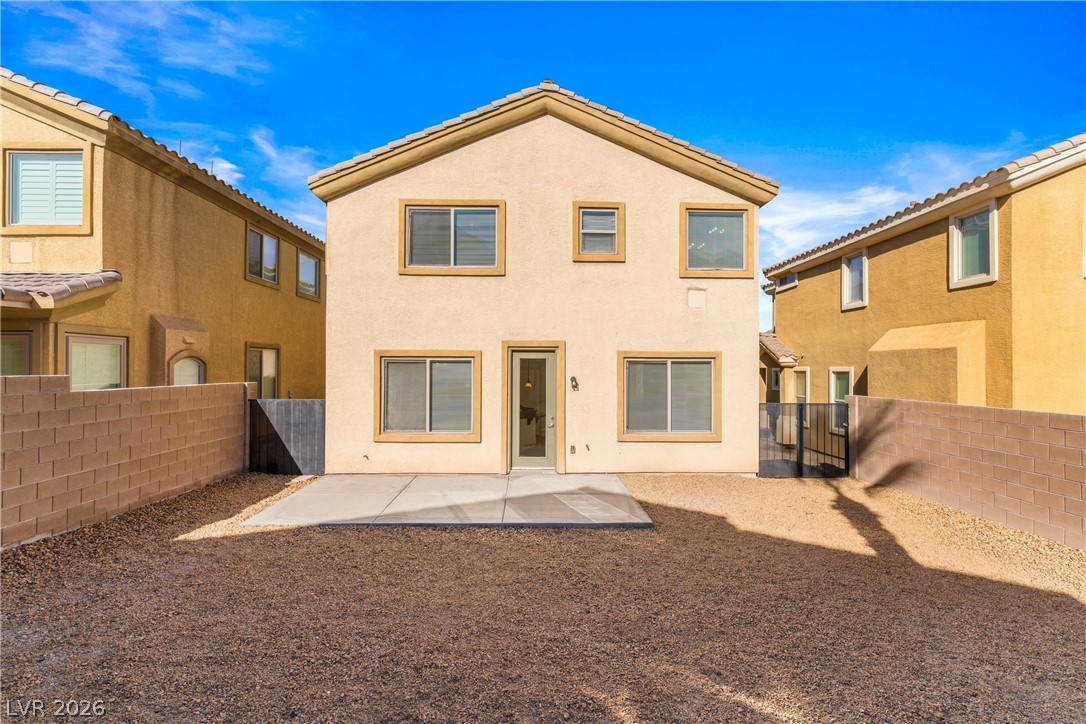 181 Short Ruff Way Las Vegas, NV 89148 - Photo 22 of 43 Rear view of house with a patio, a fenced backyard, and stucco siding