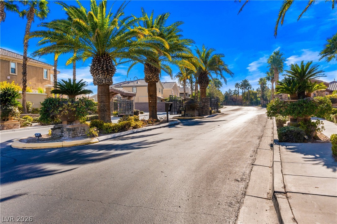 181 Short Ruff Way Las Vegas, NV 89148 - Photo 25 of 43 View of asphalt street featuring curbs, a gate, a gated entry, and sidewalks