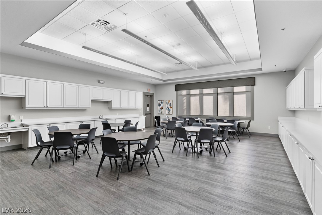 181 Short Ruff Way Las Vegas, NV 89148 - Photo 28 of 43 Dining space with a raised ceiling and light wood-style flooring