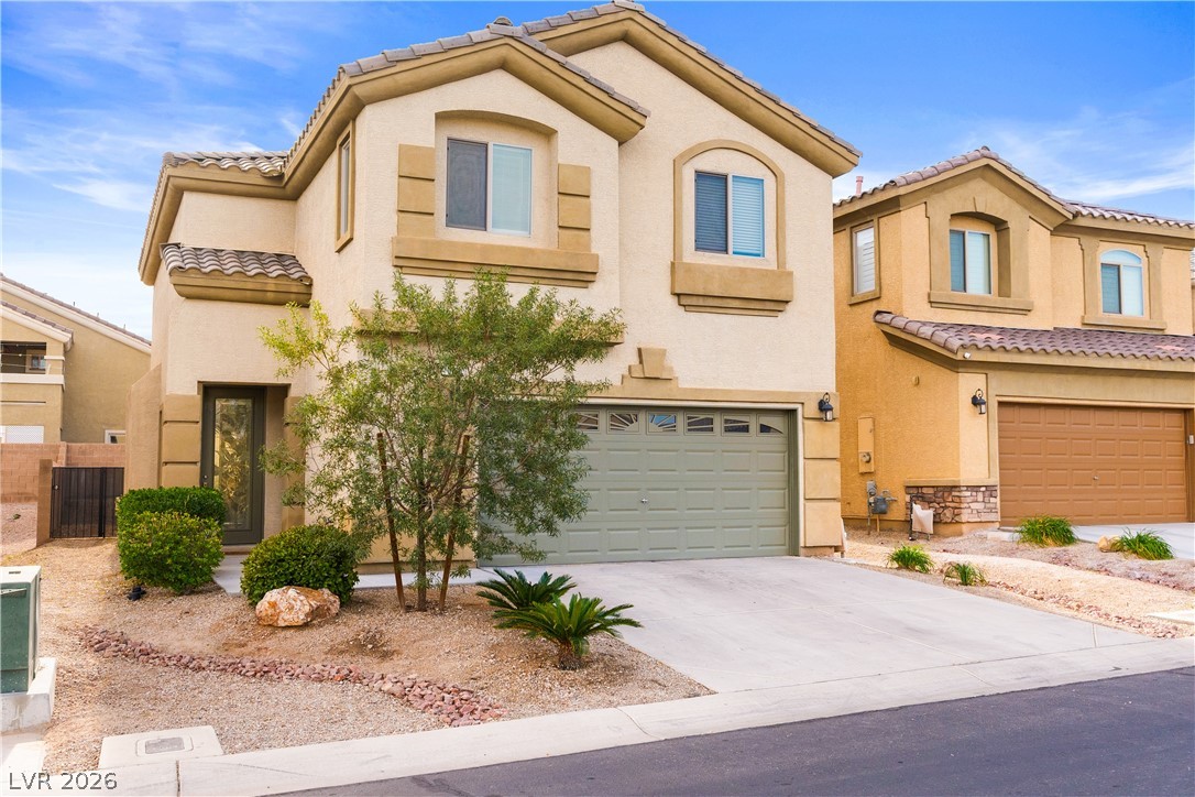 181 Short Ruff Way Las Vegas, NV 89148 - Photo 4 of 43 Mediterranean / spanish-style home with stucco siding, a tile roof, driveway, and an attached garage