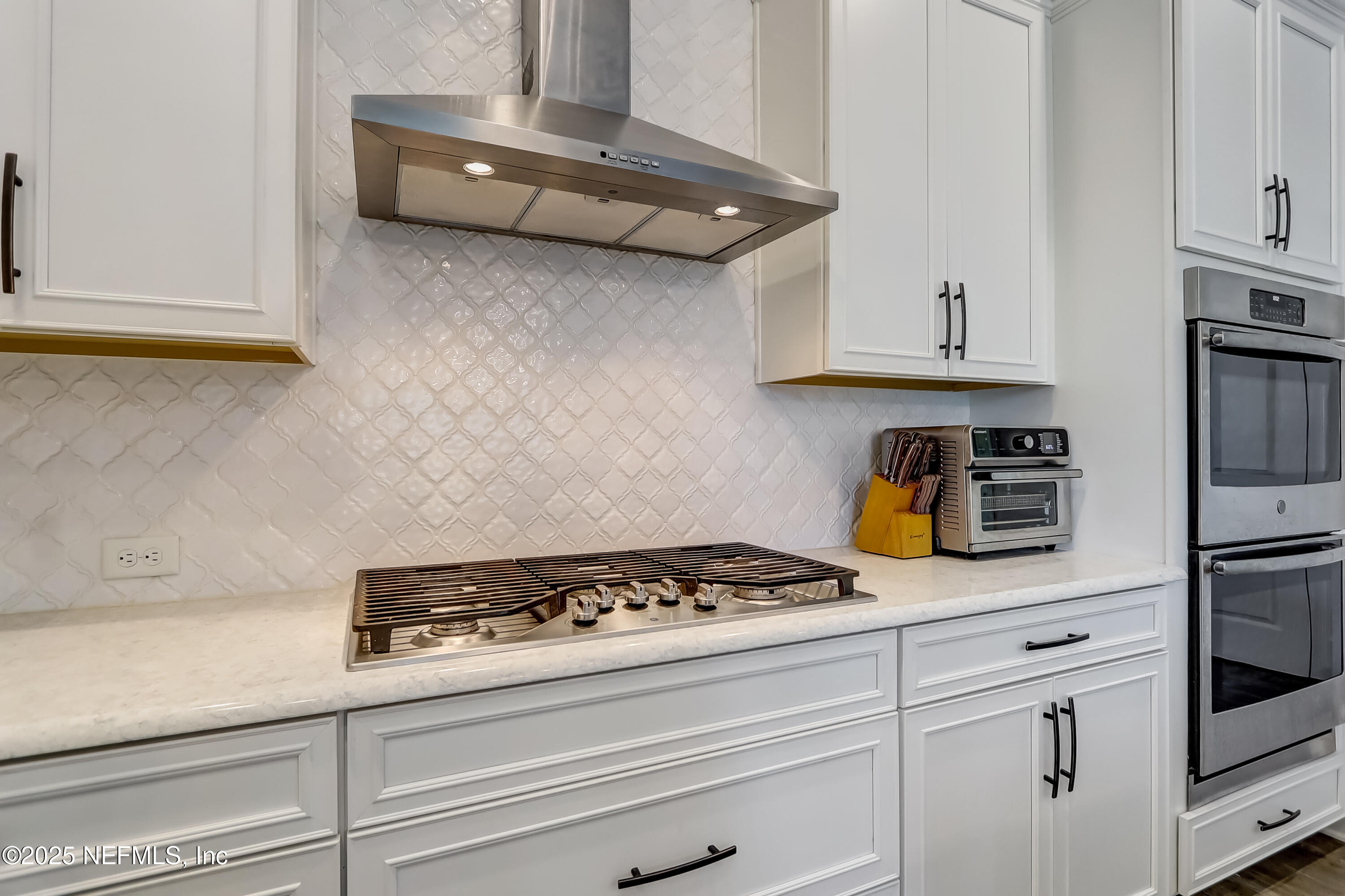 385 Daniel Park Circle Ponte Vedra, FL 32081 - Photo 14 of 34 a kitchen with white cabinets and appliances