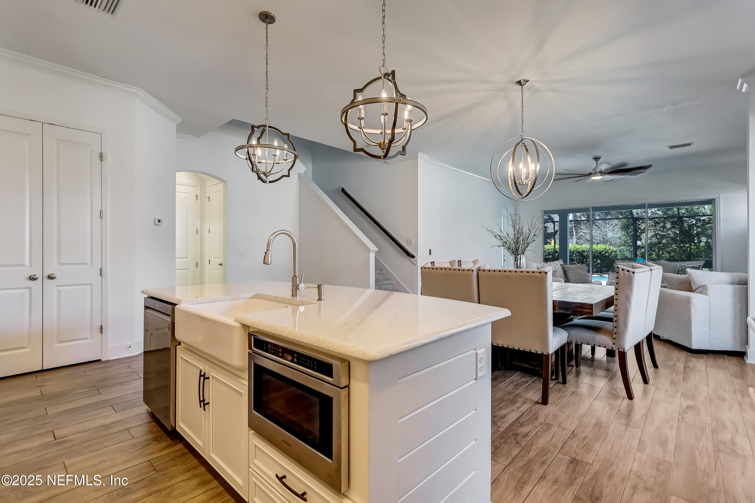 385 Daniel Park Circle Ponte Vedra, FL 32081 - Photo 15 of 34 a kitchen with a dining table a stove and a wooden floor