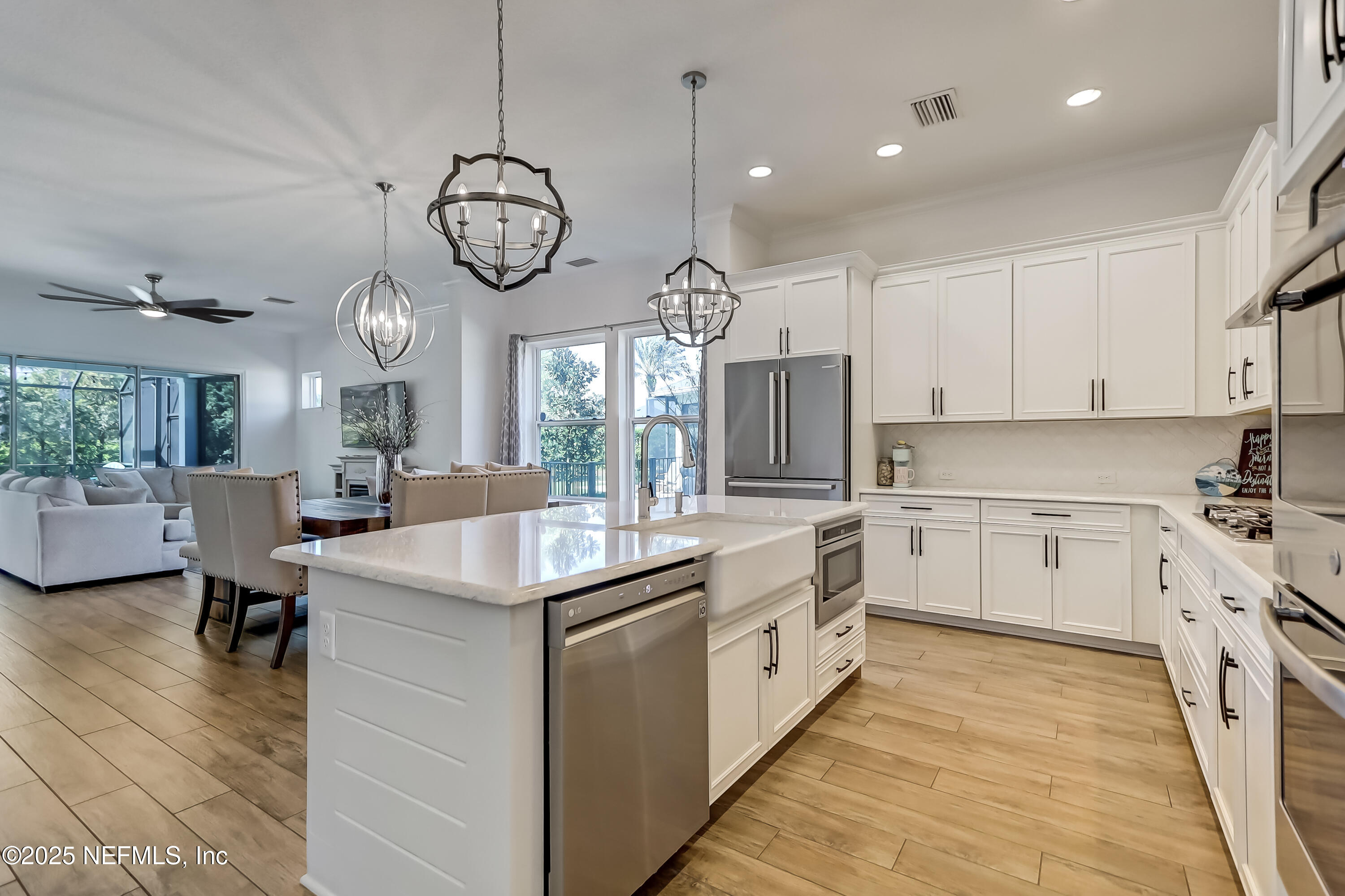 385 Daniel Park Circle Ponte Vedra, FL 32081 - Photo 17 of 34 a kitchen with white cabinets and chairs