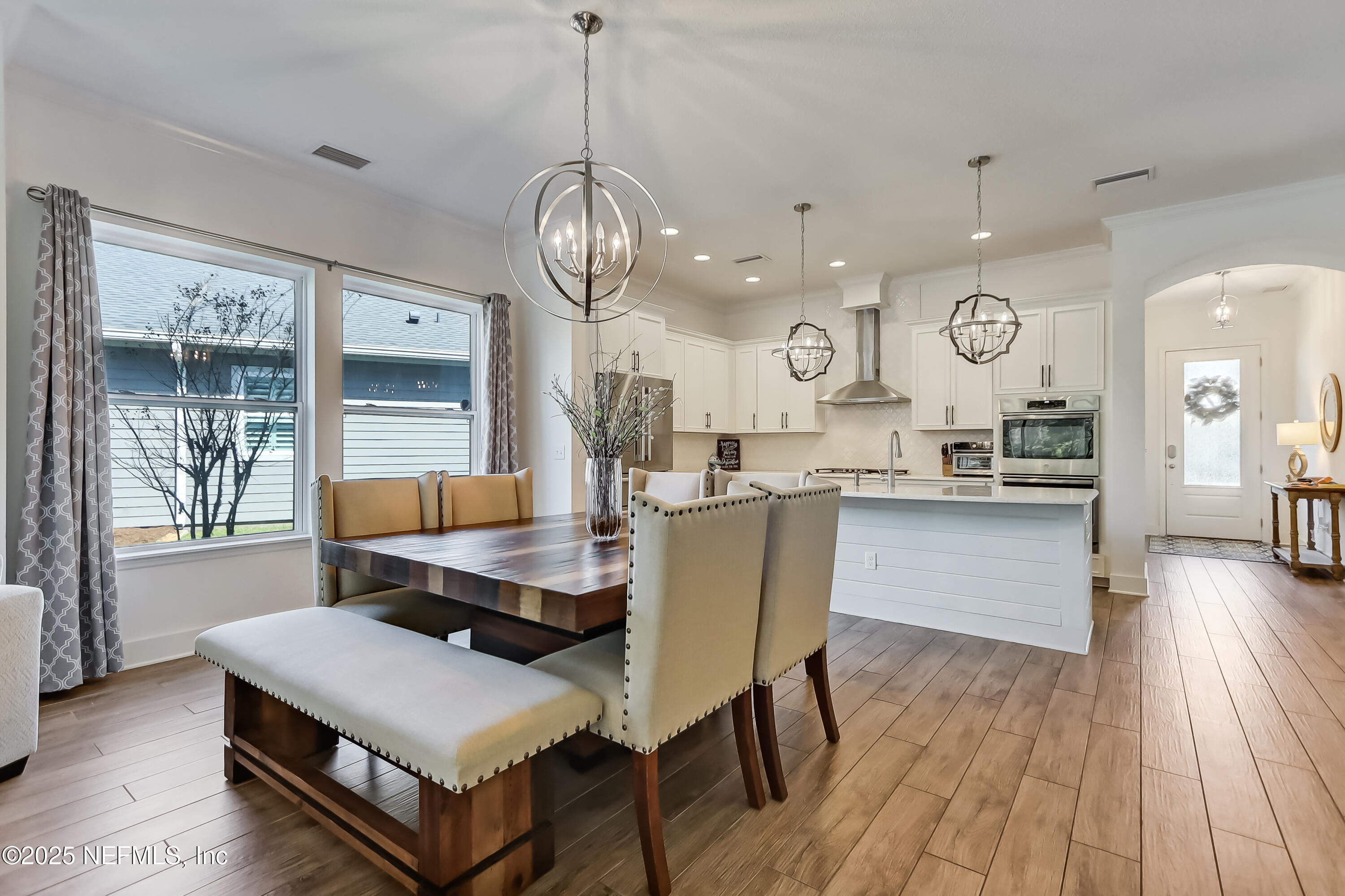 385 Daniel Park Circle Ponte Vedra, FL 32081 - Photo 19 of 34 a living room with kitchen island furniture and a chandelier