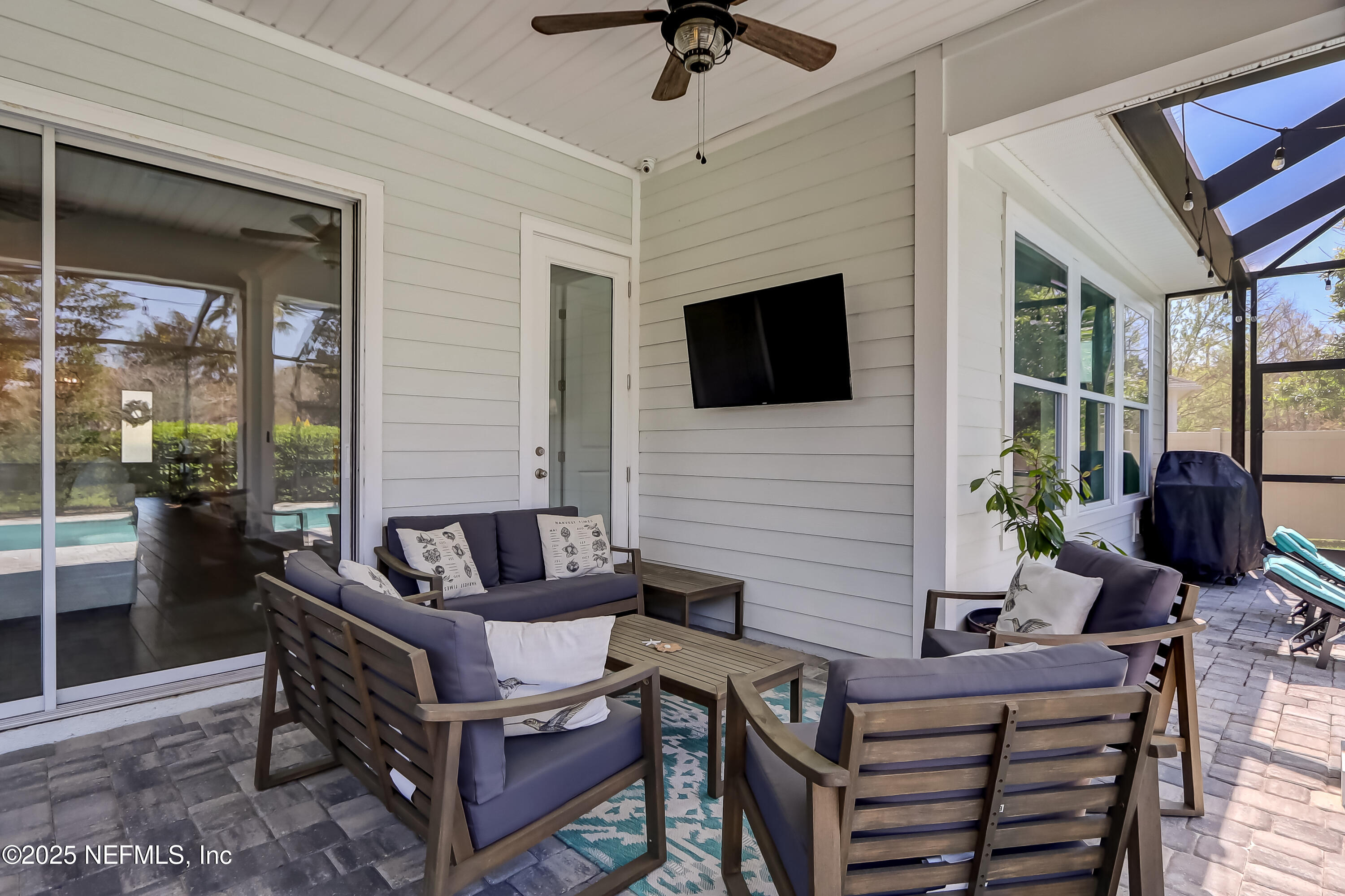 385 Daniel Park Circle Ponte Vedra, FL 32081 - Photo 27 of 34 a living room with furniture a flat screen tv and a fireplace