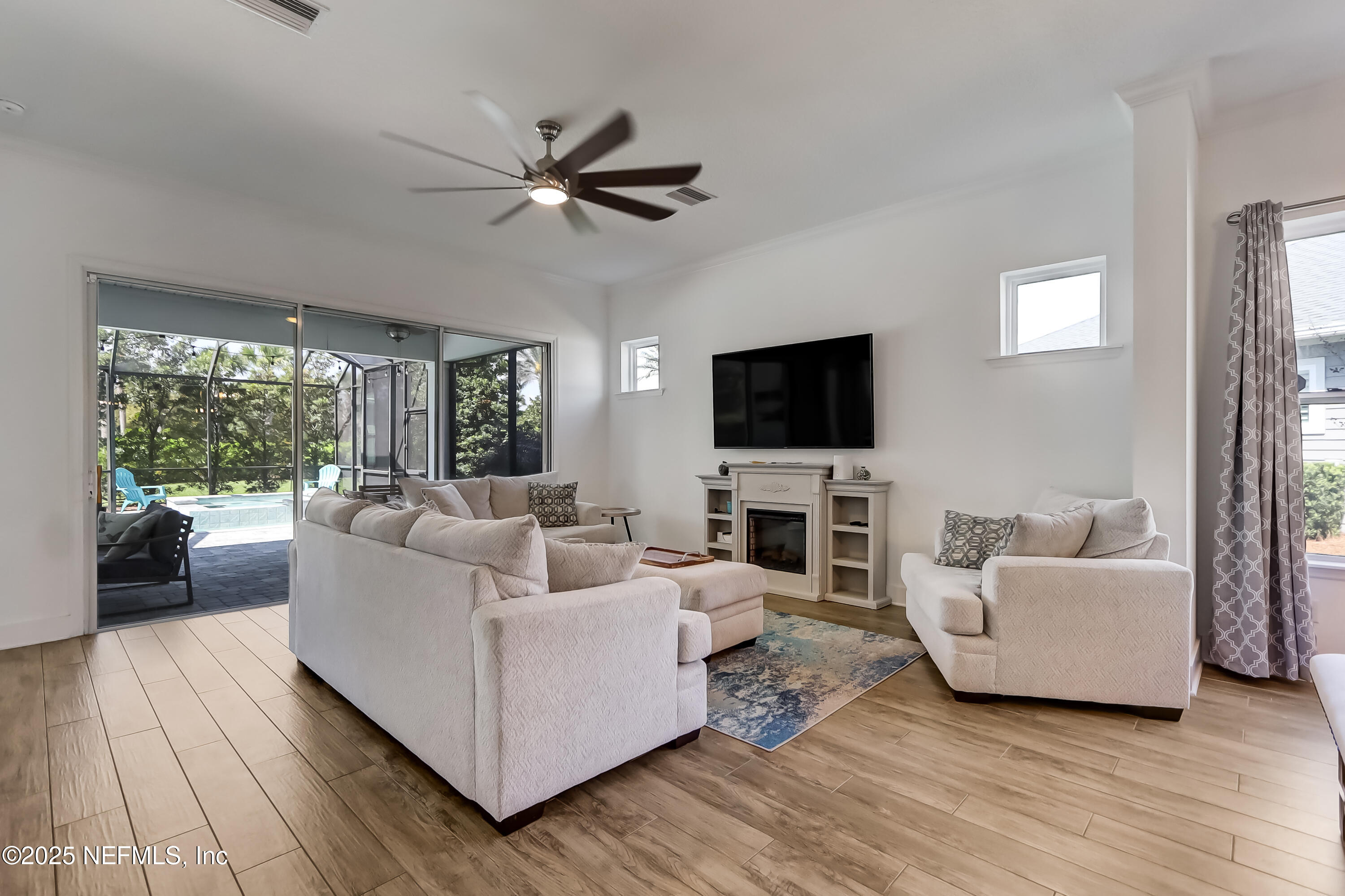 385 Daniel Park Circle Ponte Vedra, FL 32081 - Photo 9 of 34 a living room with furniture and a flat screen tv