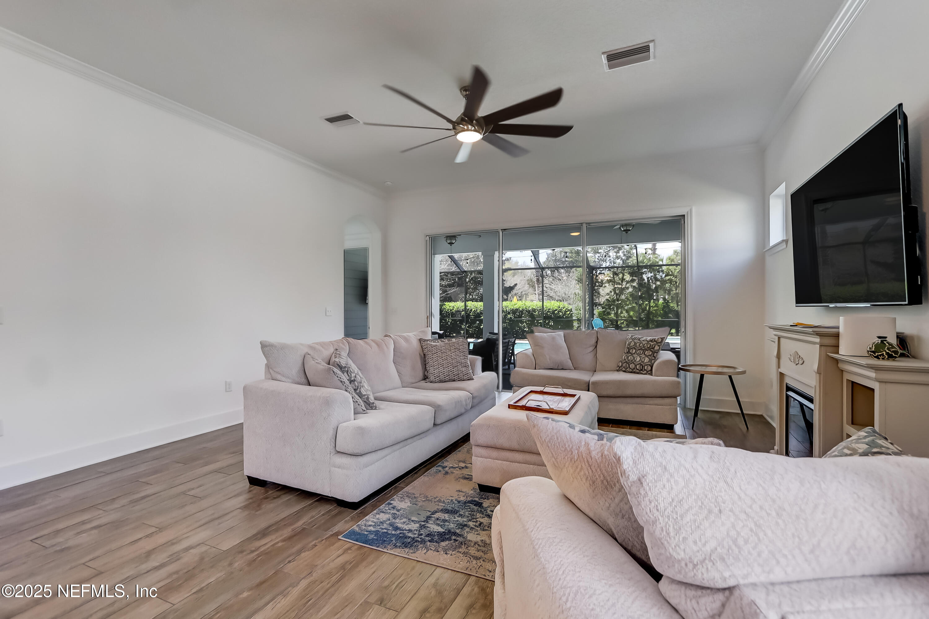 385 Daniel Park Circle Ponte Vedra, FL 32081 - Photo 10 of 34 a living room with furniture a ceiling fan and a flat screen tv