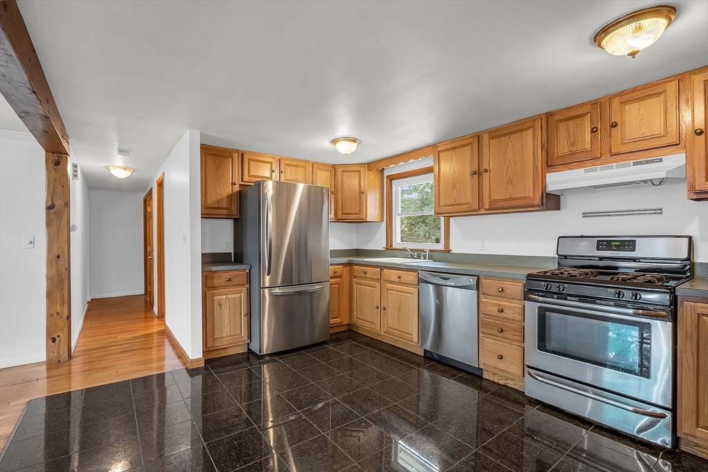 36 Mill Street Maynard, MA 01754 - Photo 11 of 42 a kitchen with refrigerator cabinets and wooden floor
