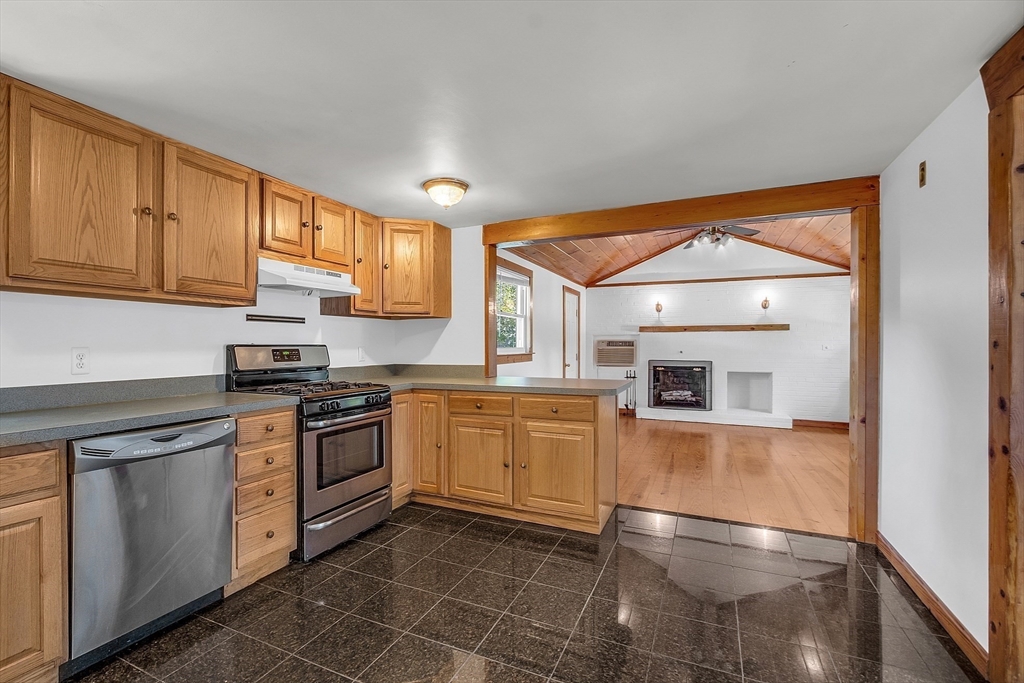 36 Mill Street Maynard, MA 01754 - Photo 13 of 42 a kitchen with stainless steel appliances granite countertop a stove a sink and white cabinets