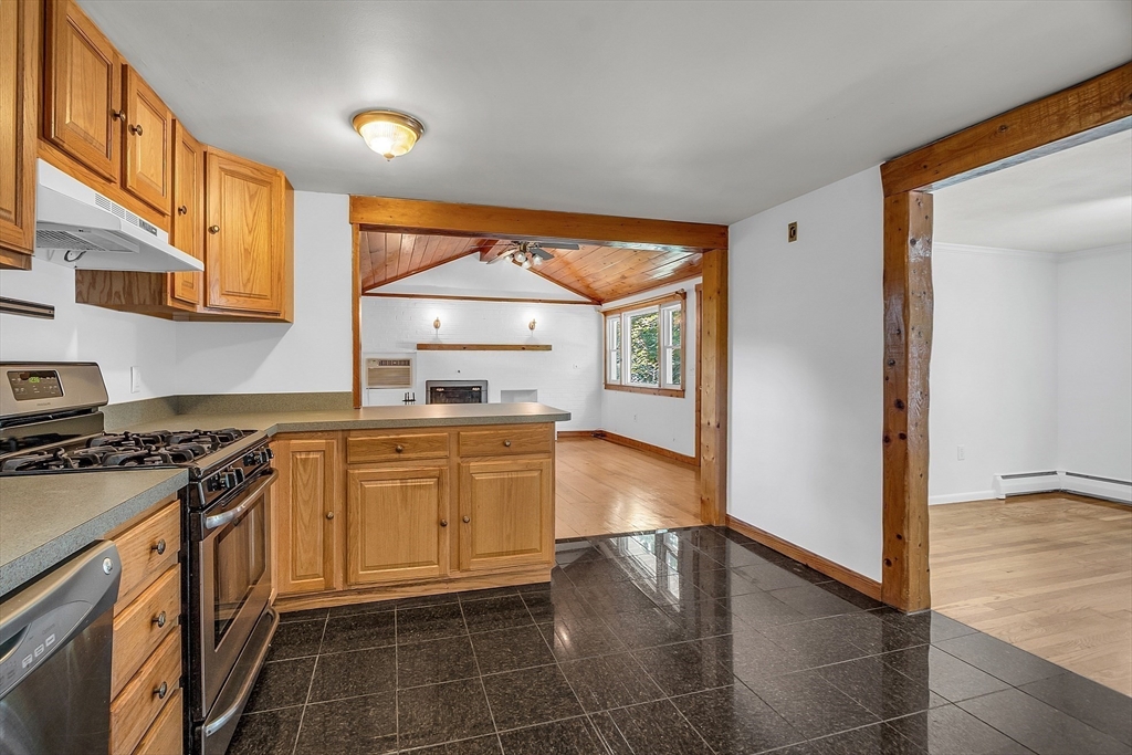 36 Mill Street Maynard, MA 01754 - Photo 14 of 42 a kitchen with a stove a sink and a refrigerator