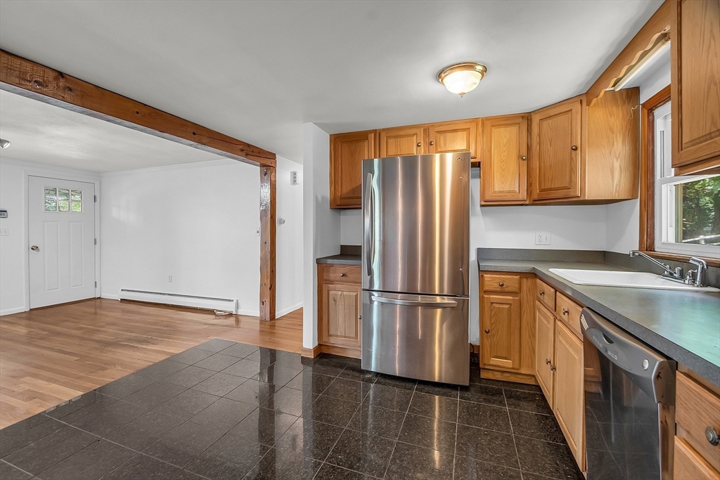 36 Mill Street Maynard, MA 01754 - Photo 15 of 42 a kitchen with stainless steel appliances granite countertop a refrigerator a sink and a stove