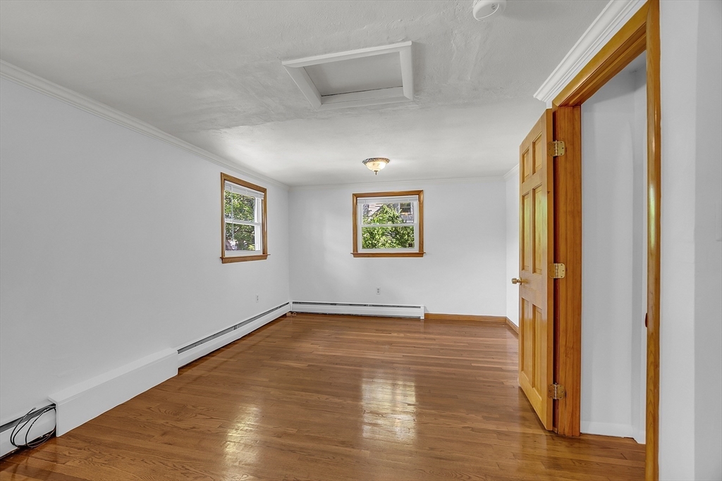 36 Mill Street Maynard, MA 01754 - Photo 21 of 42 a view of an empty room with wooden floor and a window