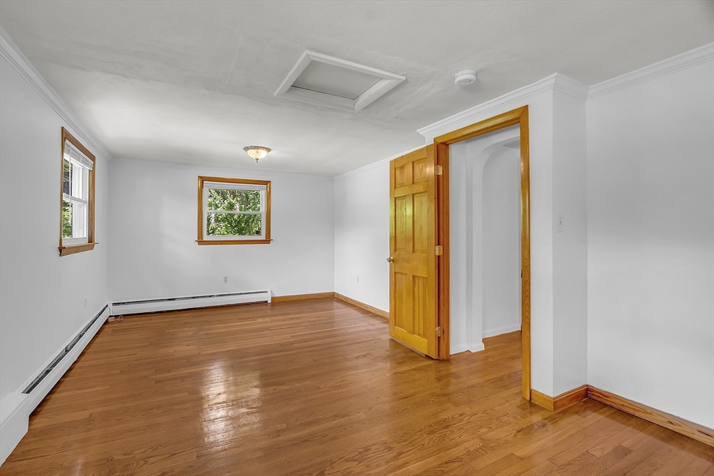 36 Mill Street Maynard, MA 01754 - Photo 22 of 42 a view of an empty room with window and wooden floor