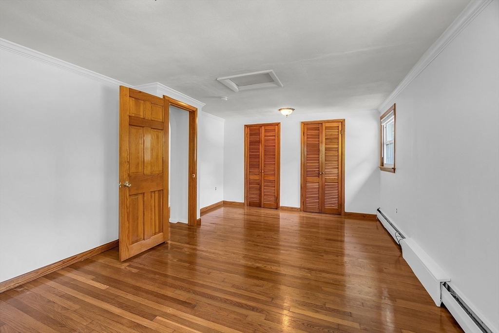 36 Mill Street Maynard, MA 01754 - Photo 23 of 42 a view of an empty room with wooden floor and a window