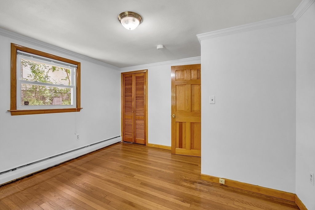 36 Mill Street Maynard, MA 01754 - Photo 25 of 42 an empty room with wooden floor and windows