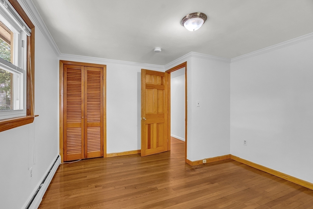 36 Mill Street Maynard, MA 01754 - Photo 26 of 42 an empty room with wooden floor and windows
