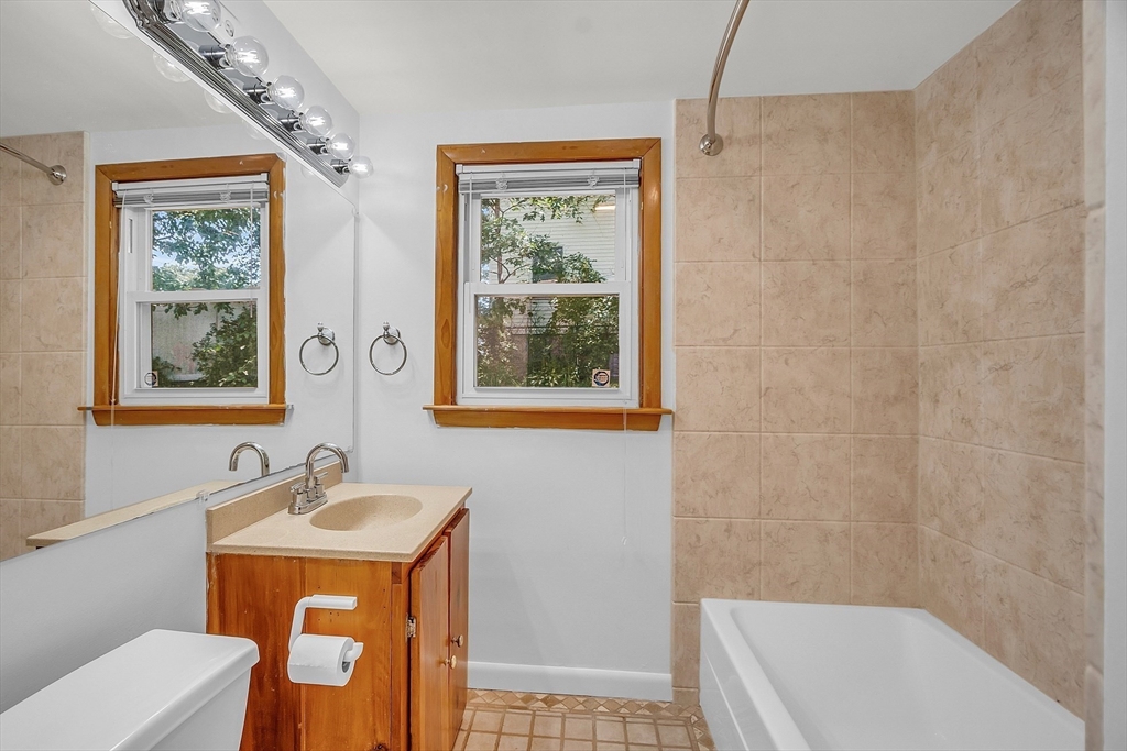 36 Mill Street Maynard, MA 01754 - Photo 27 of 42 a bathroom with a sink a toilet and a shower