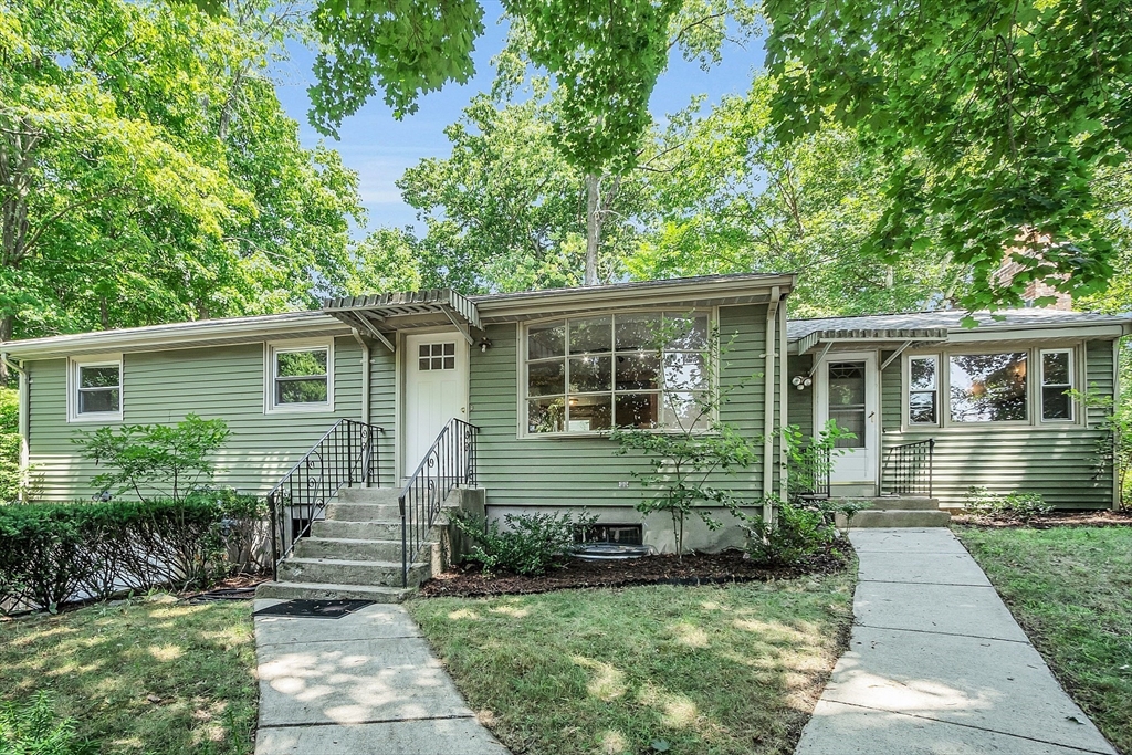 36 Mill Street Maynard, MA 01754 - Photo 40 of 42 a front view of a house with garden