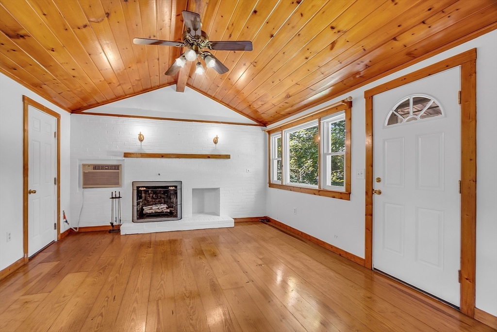 36 Mill Street Maynard, MA 01754 - Photo 4 of 42 a view of a livingroom with a fireplace and window