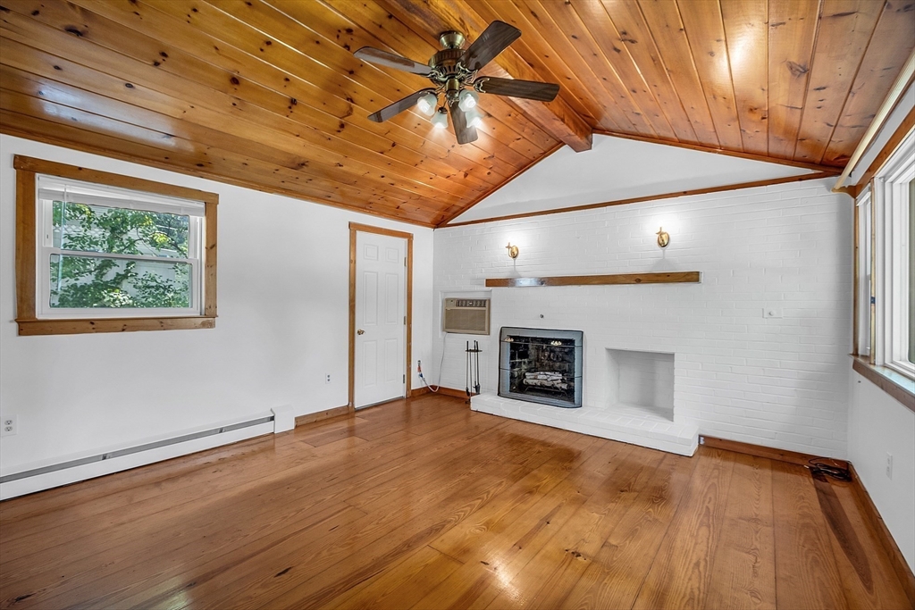 36 Mill Street Maynard, MA 01754 - Photo 6 of 42 a view of an empty room with a fireplace and a window