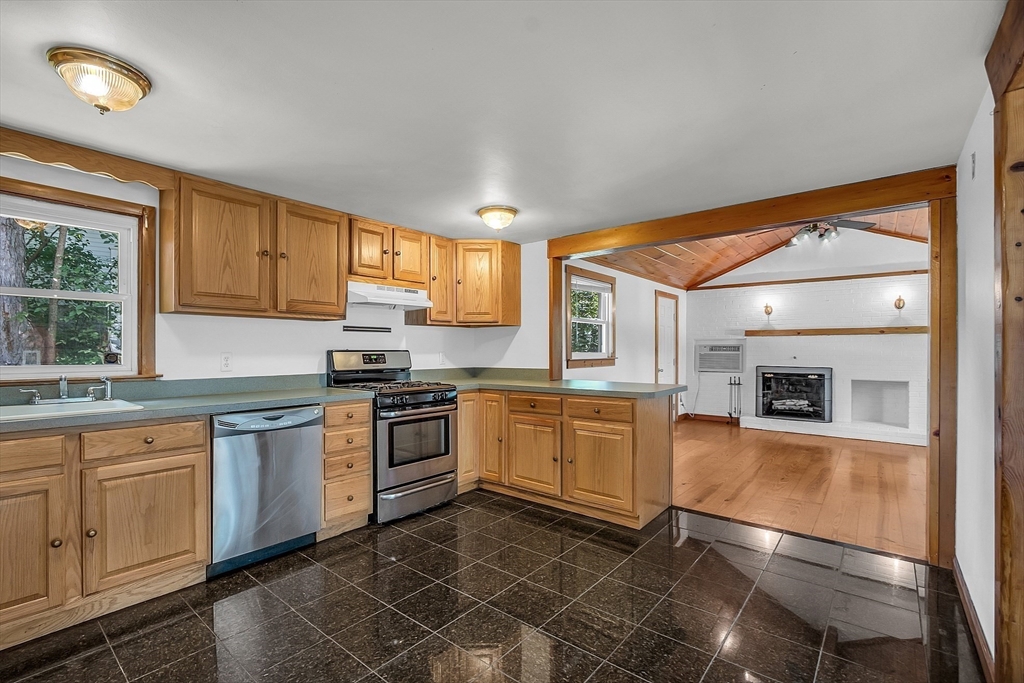 36 Mill Street Maynard, MA 01754 - Photo 9 of 42 a kitchen with stainless steel appliances granite countertop a stove a sink and a microwave