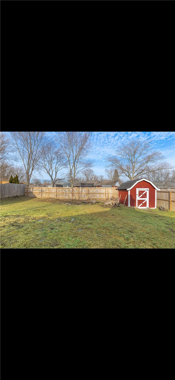 10 Monroe Road Lebanon, OH 45036 - Photo 10 of 14 This spacious yard features a wooden fence and a charming storage shed.