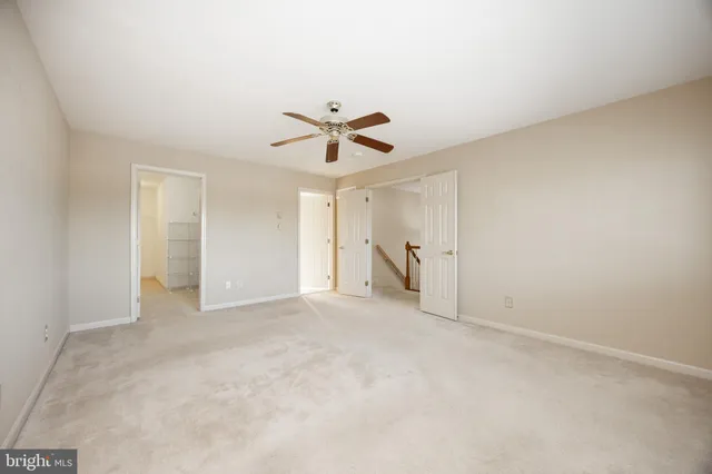 a view of room with a ceiling fan and window