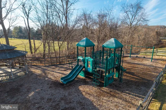 a view of a park with iron fence