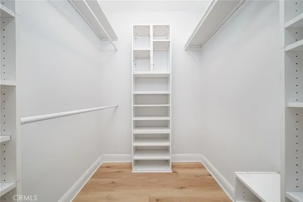 a view of walk in closet with empty racks