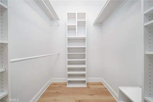 a view of walk in closet with empty racks