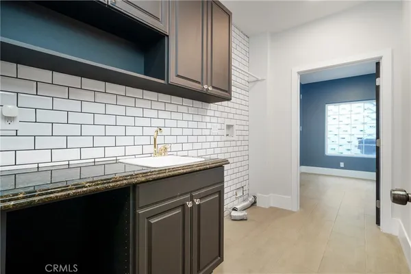 a kitchen with a sink and cabinets