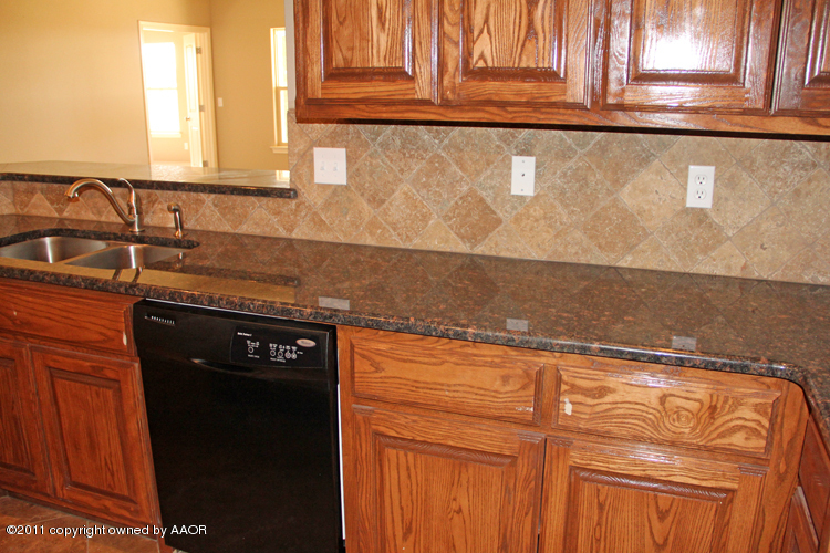 18451 Grasslands Road Bushland, TX 79124 - Photo 13 of 39 a close view of a sink a mirror and cabinets