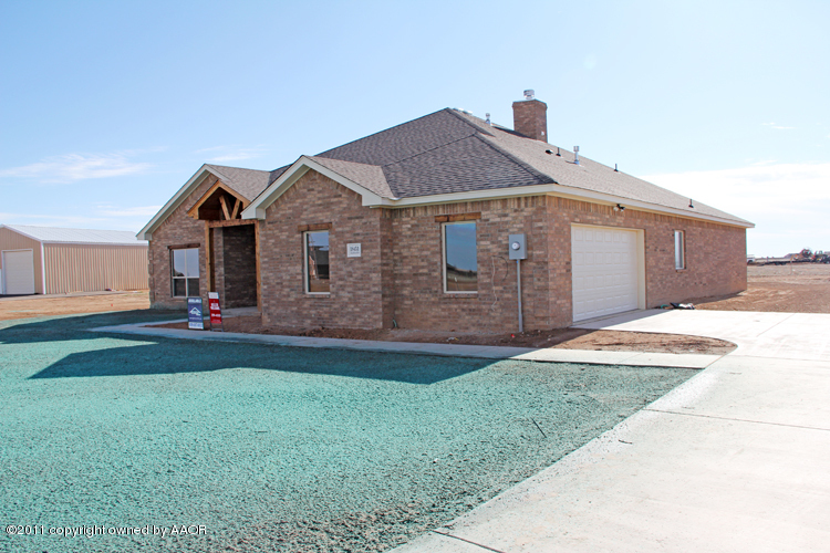 18451 Grasslands Road Bushland, TX 79124 - Photo 2 of 39 a front view of a house with a yard and garage
