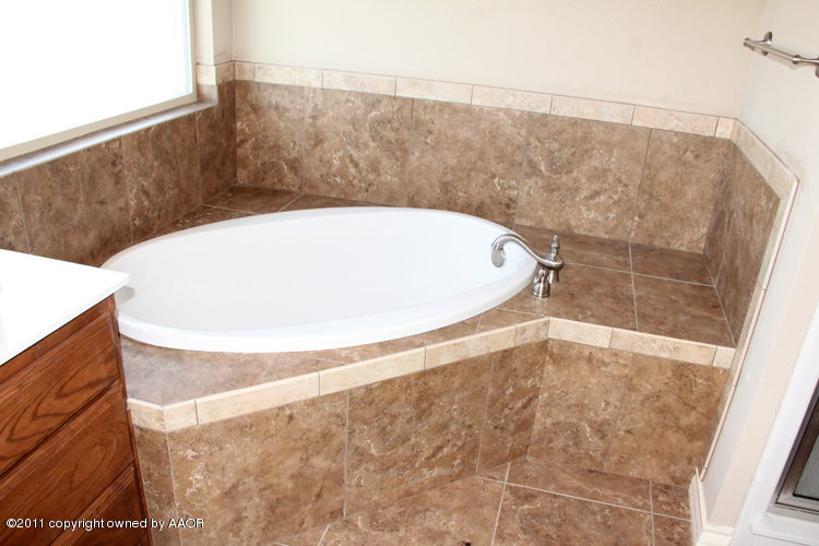 18451 Grasslands Road Bushland, TX 79124 - Photo 21 of 39 a bathroom with a bathtub and shower