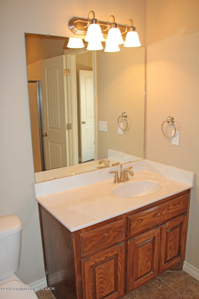 18451 Grasslands Road Bushland, TX 79124 - Photo 30 of 39 a bathroom with a sink vanity and a mirror