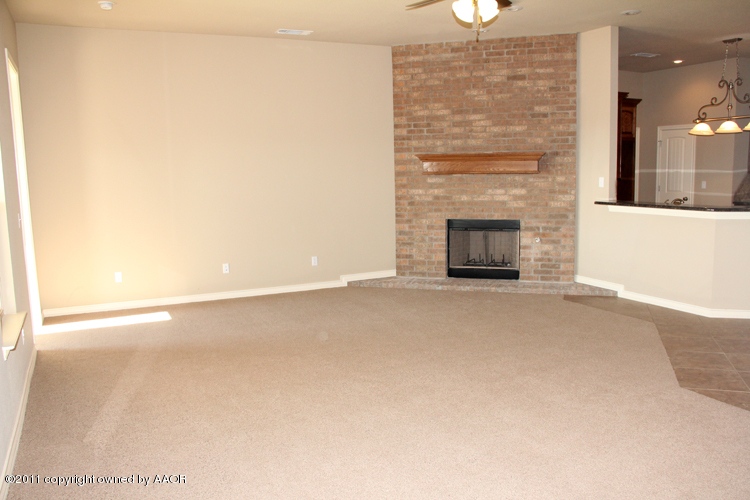 18451 Grasslands Road Bushland, TX 79124 - Photo 6 of 39 a view of a livingroom with a fireplace