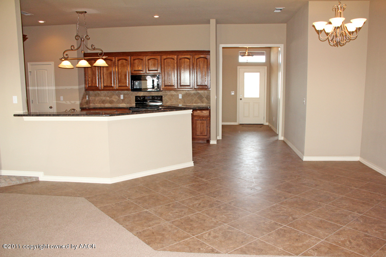 18451 Grasslands Road Bushland, TX 79124 - Photo 7 of 39 a view of kitchen with granite countertop cabinets and refrigerator