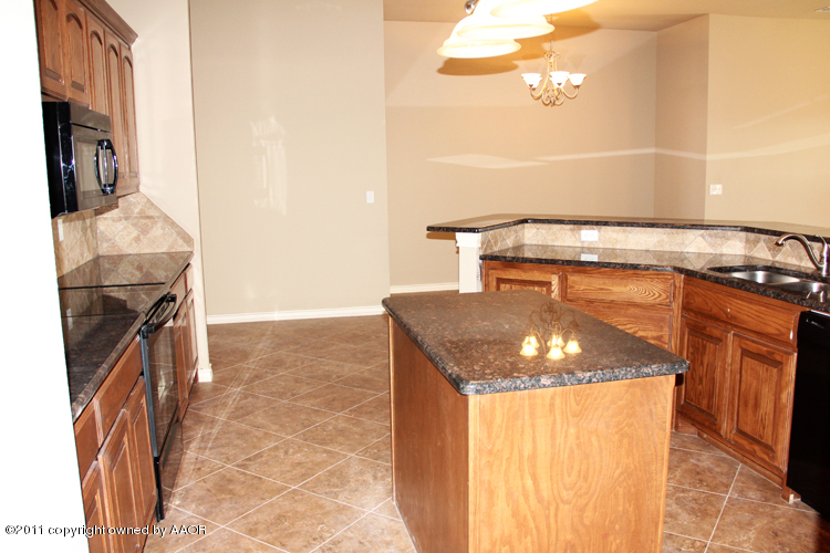18451 Grasslands Road Bushland, TX 79124 - Photo 10 of 39 a utility room with granite countertop a sink and a stove