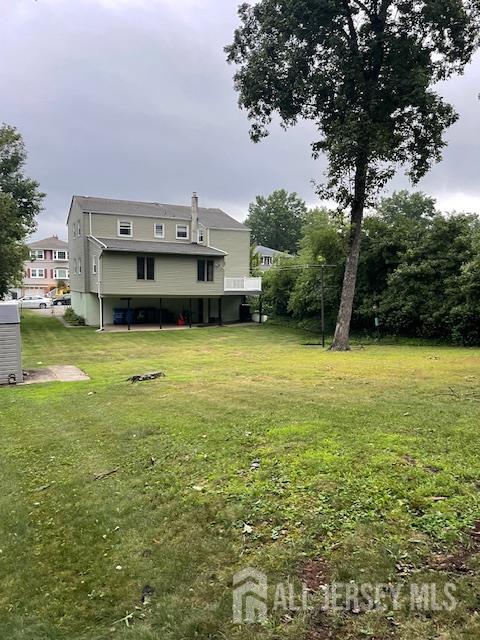 55 Murdock Street Fords, NJ 08863 - Photo 34 of 42 a view of a pool with lawn chairs and a large tree