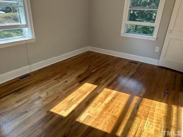 a view of an empty room and wooden floor