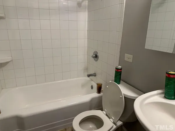 a bathroom with a toilet and bathtub