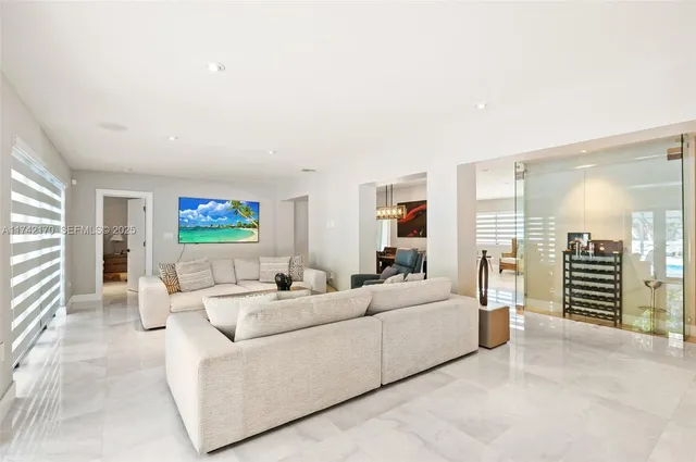 a kitchen with kitchen island a stove a table and chairs in it