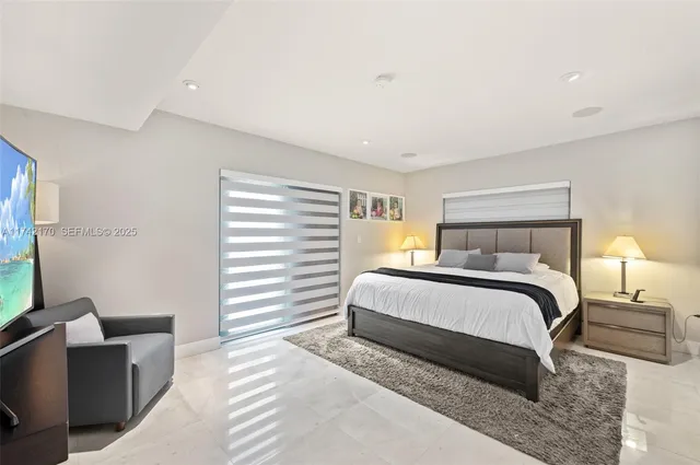 a bedroom with a bed and a lamp